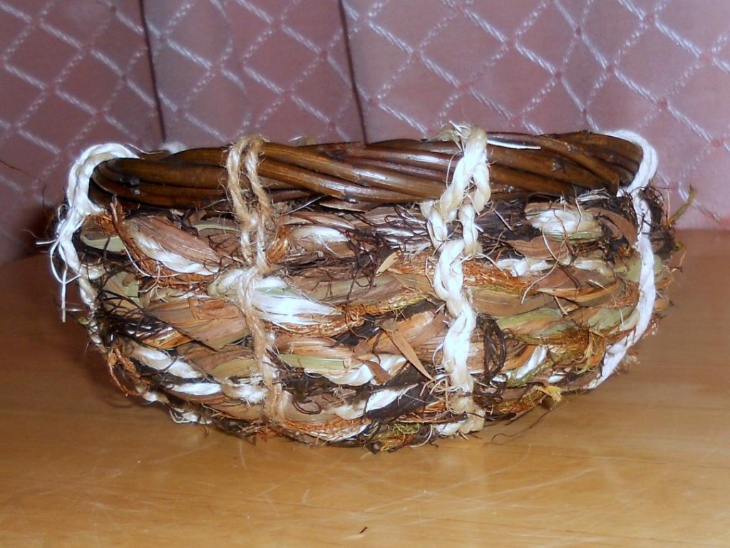 Side view of basket made with rope made from montbretia leaves, seaweed, hair moss, string and leftover willow